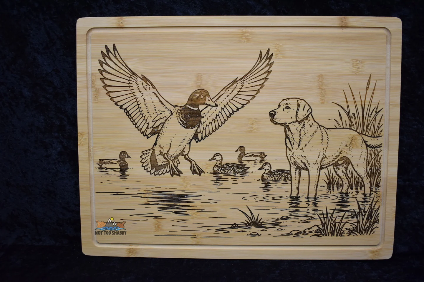 Duck and Labrador hunting scene engraved on a cutting board