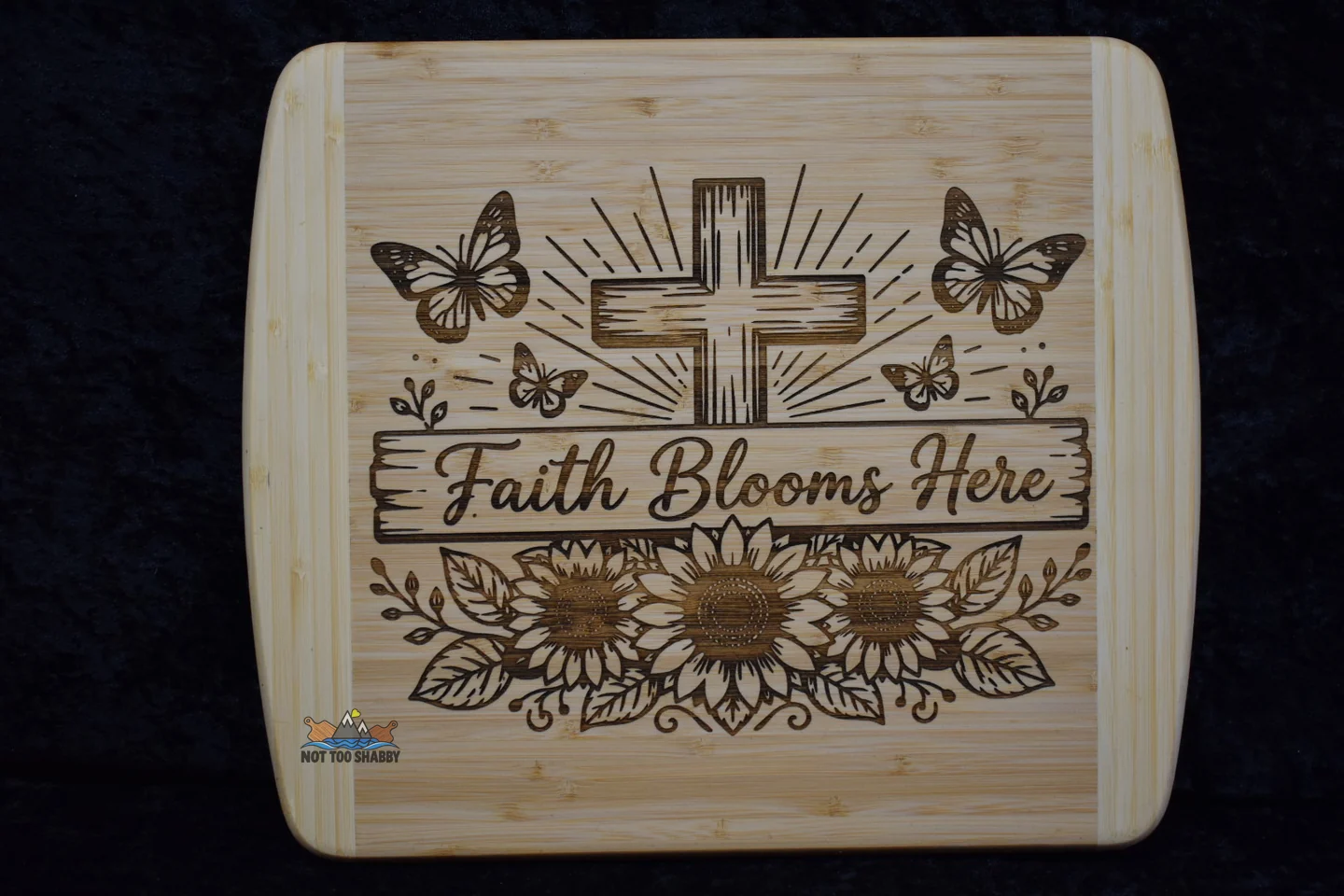 Faith Blooms Here design engraved on a cutting board